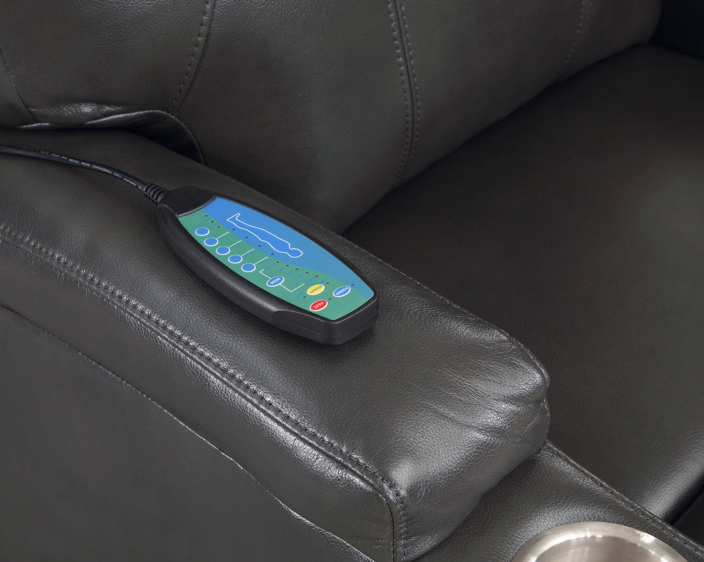 Black leather recliner with integrated massage controller on armrest