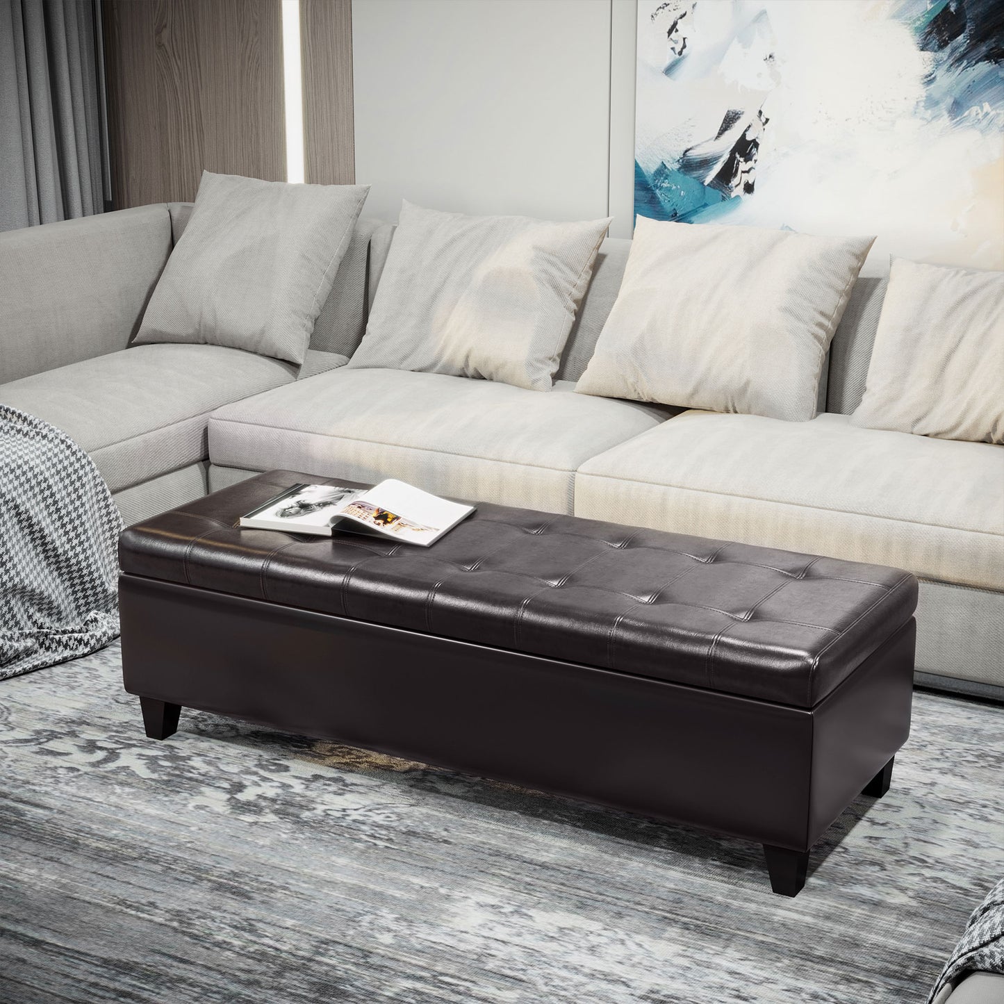 Tufted dark brown faux leather storage ottoman with a magazine resting on top
