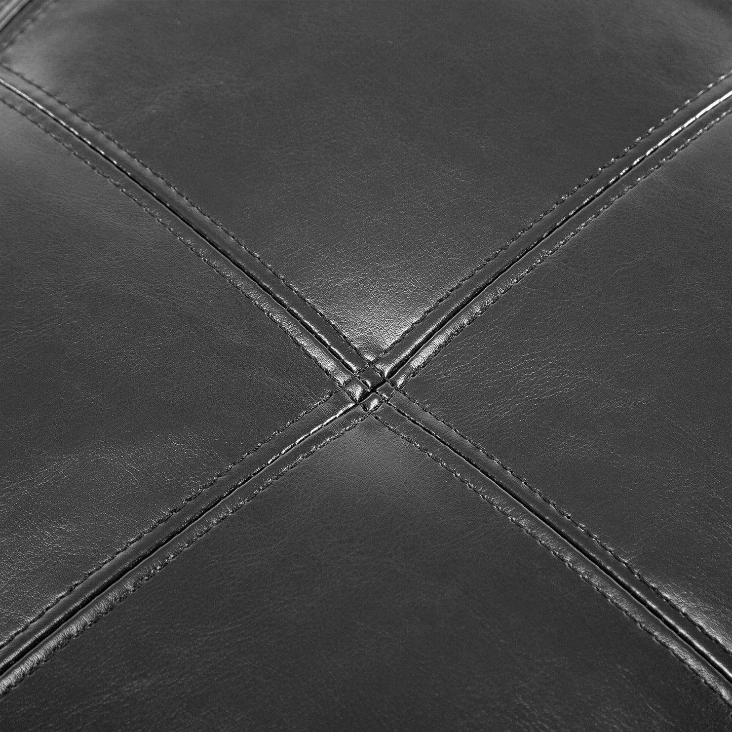 Close up of stitched black vegan leather upholstery with diamond pattern