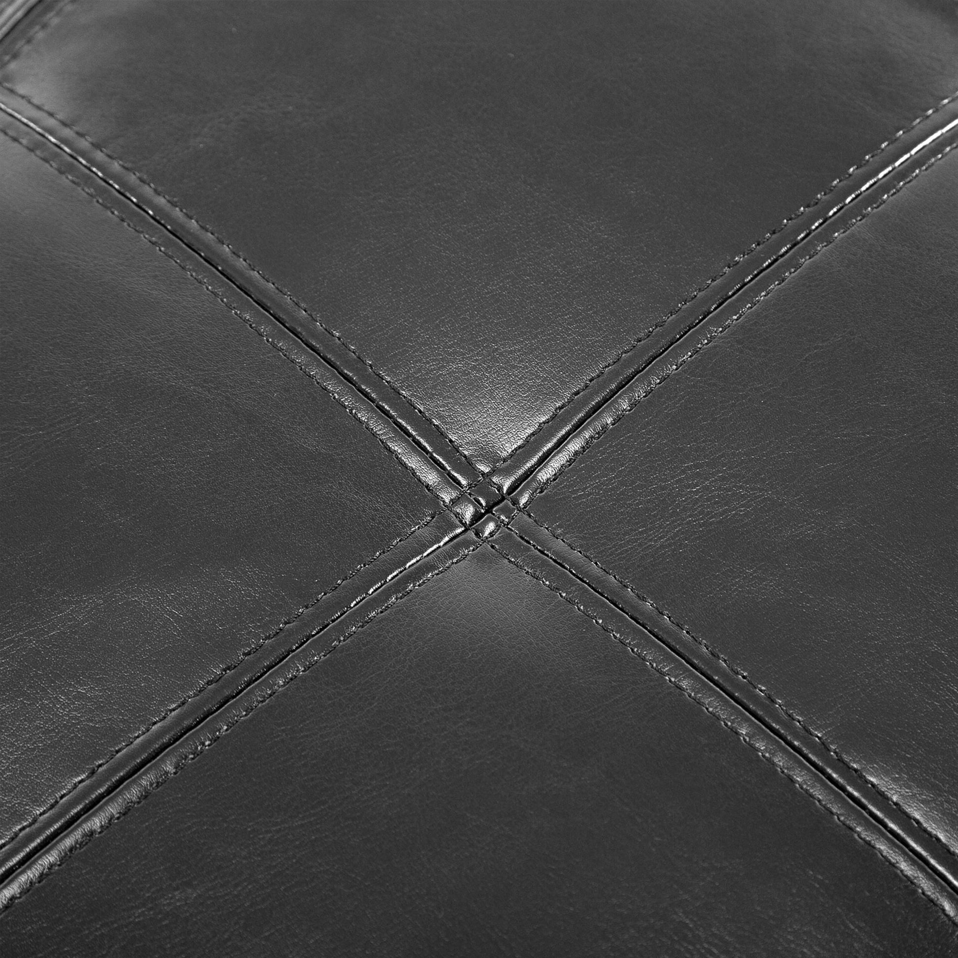 Close up of stitched black vegan leather upholstery with diamond pattern
