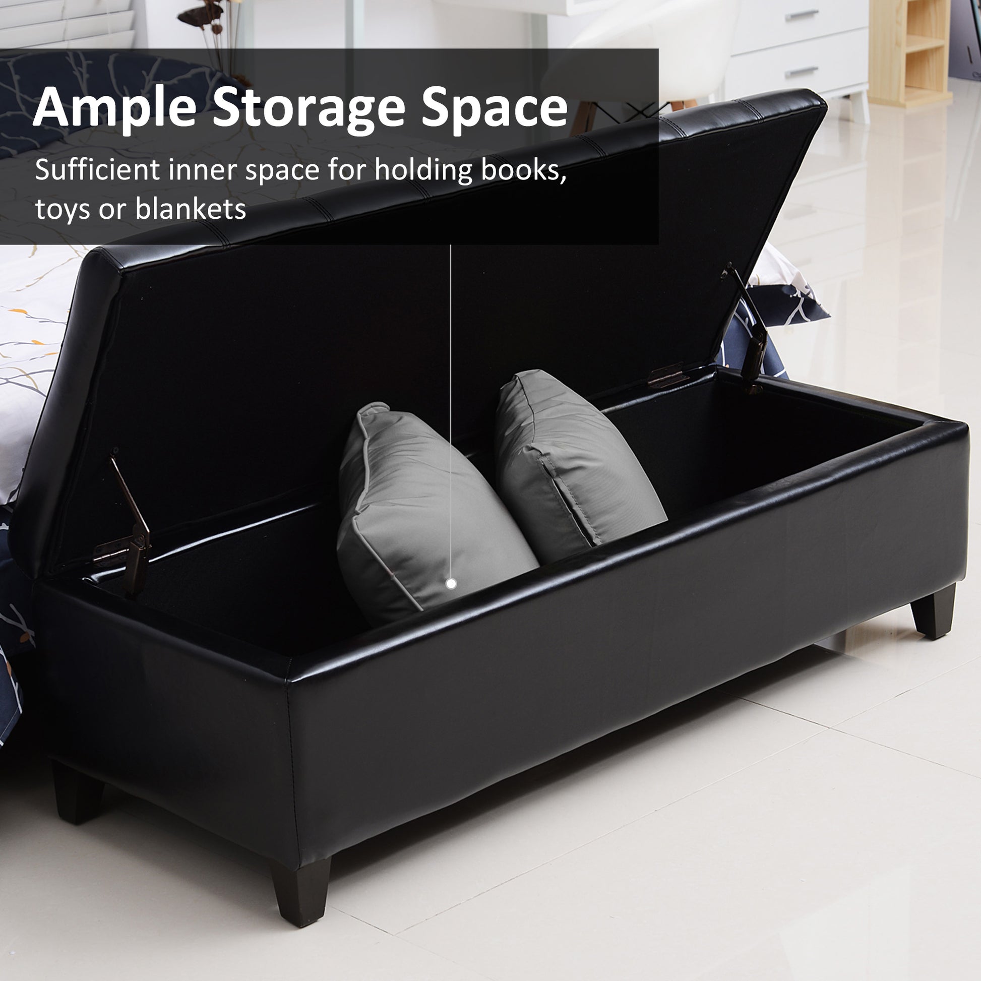 Black faux leather storage ottoman with plush pillows inside offering ample storage space