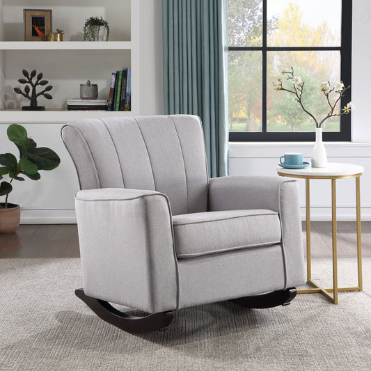 Light gray upholstered rocking chair with dark wood base perfect for nursery
