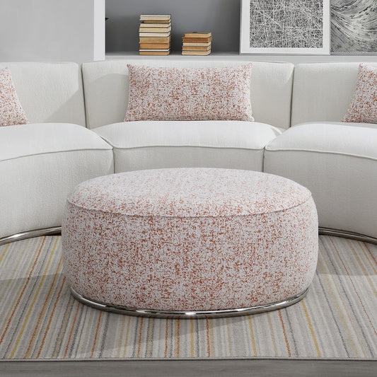 Round upholstered ottoman with speckled orange and white fabric and silver base