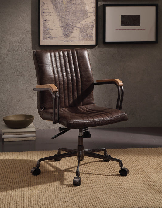 Distressed brown leather office chair with tufted back and wooden arms