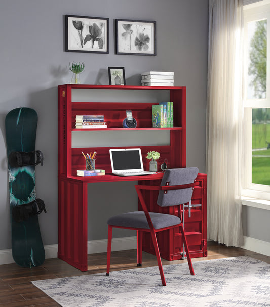 Red shipping container style desk with integrated shelving and a laptop
