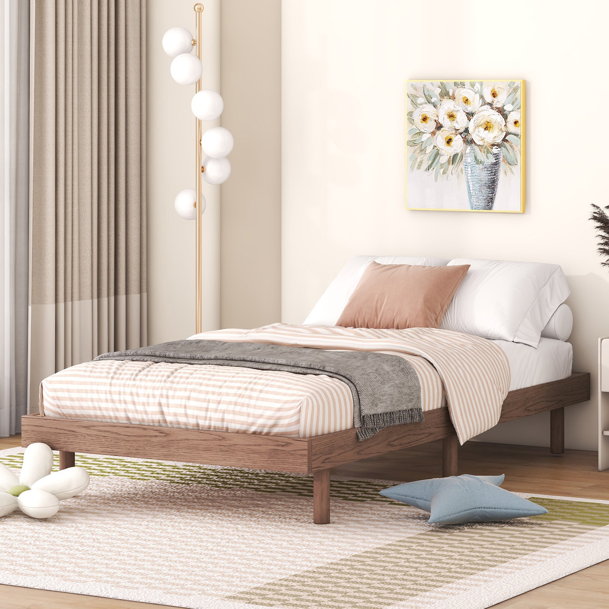 Twin size wooden bed frame with striped bedding and grey throw