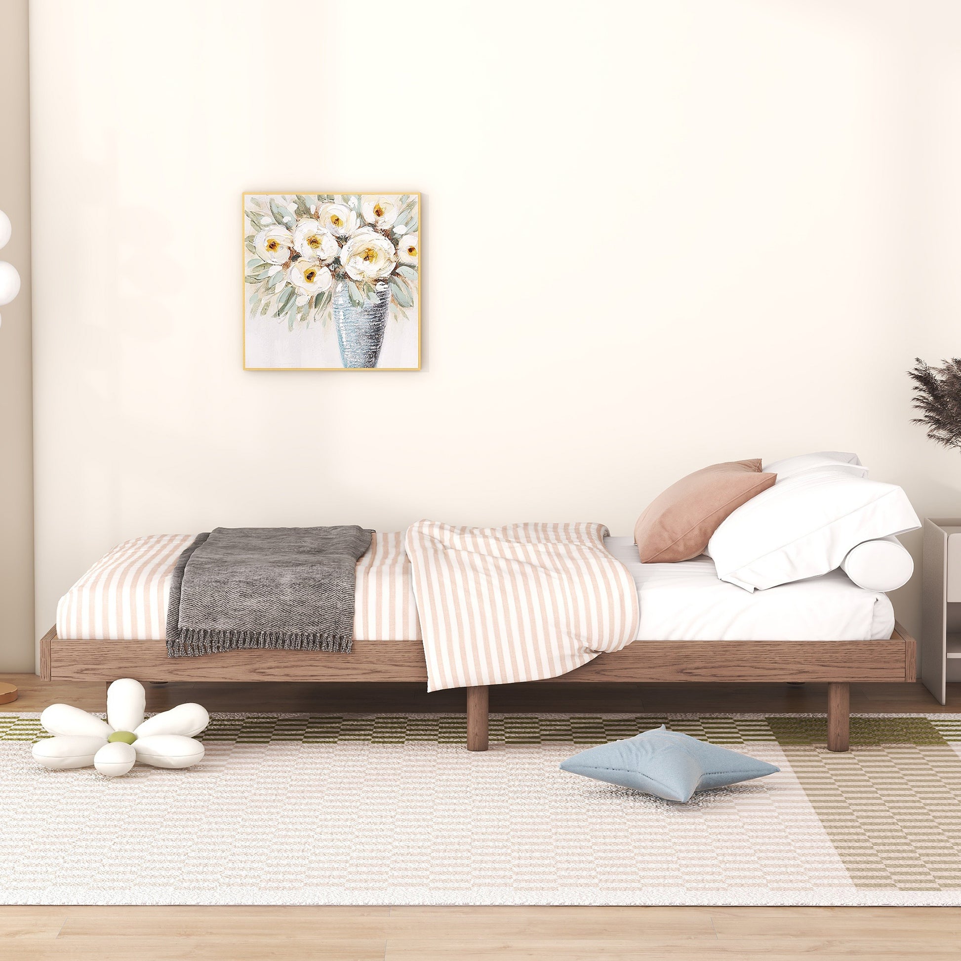 Wooden daybed with striped bedding and grey throw blanket
