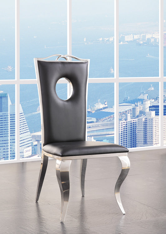 Black upholstered dining chair with polished chrome legs and a circular back cutout