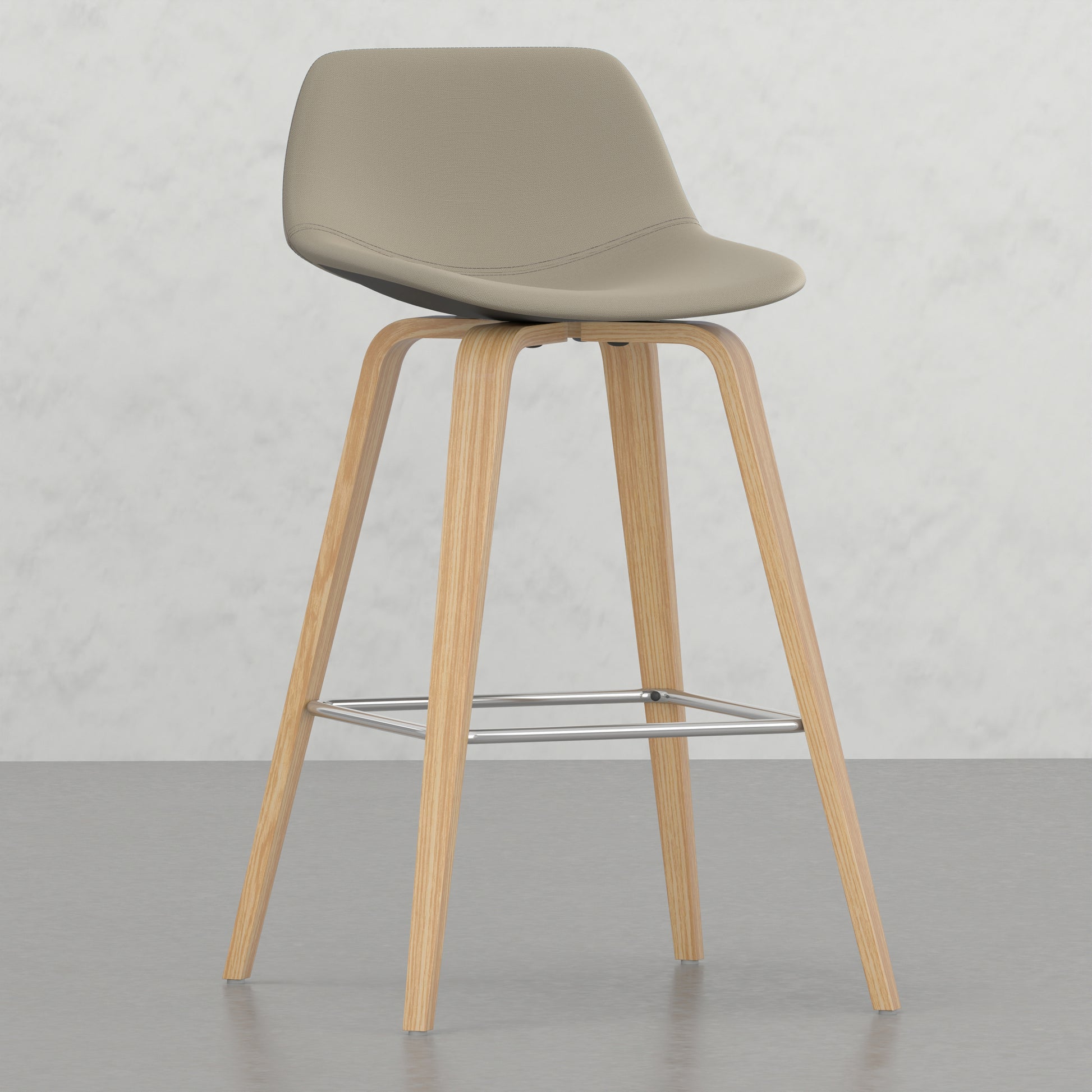 Beige fabric bar stool with light wood legs and chrome footrest