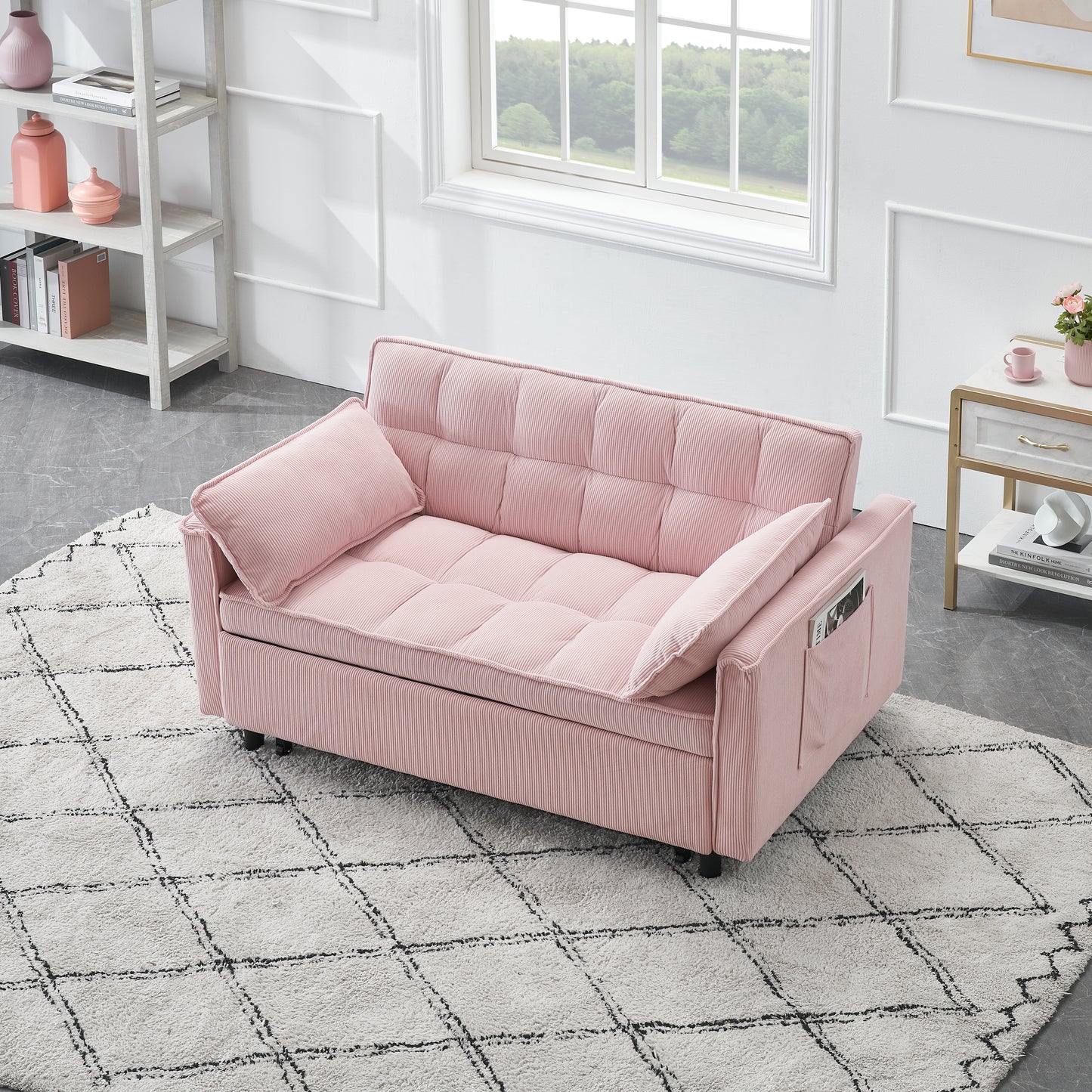 Pink corduroy sofa bed with tufted cushions and two throw pillows