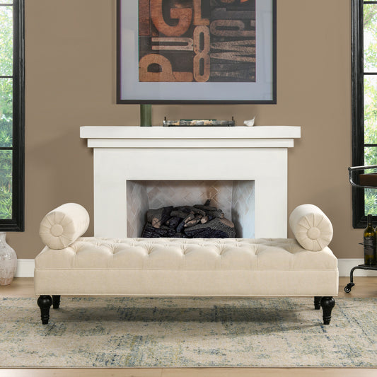 Tufted beige fabric bench with bolster arms and dark wood legs