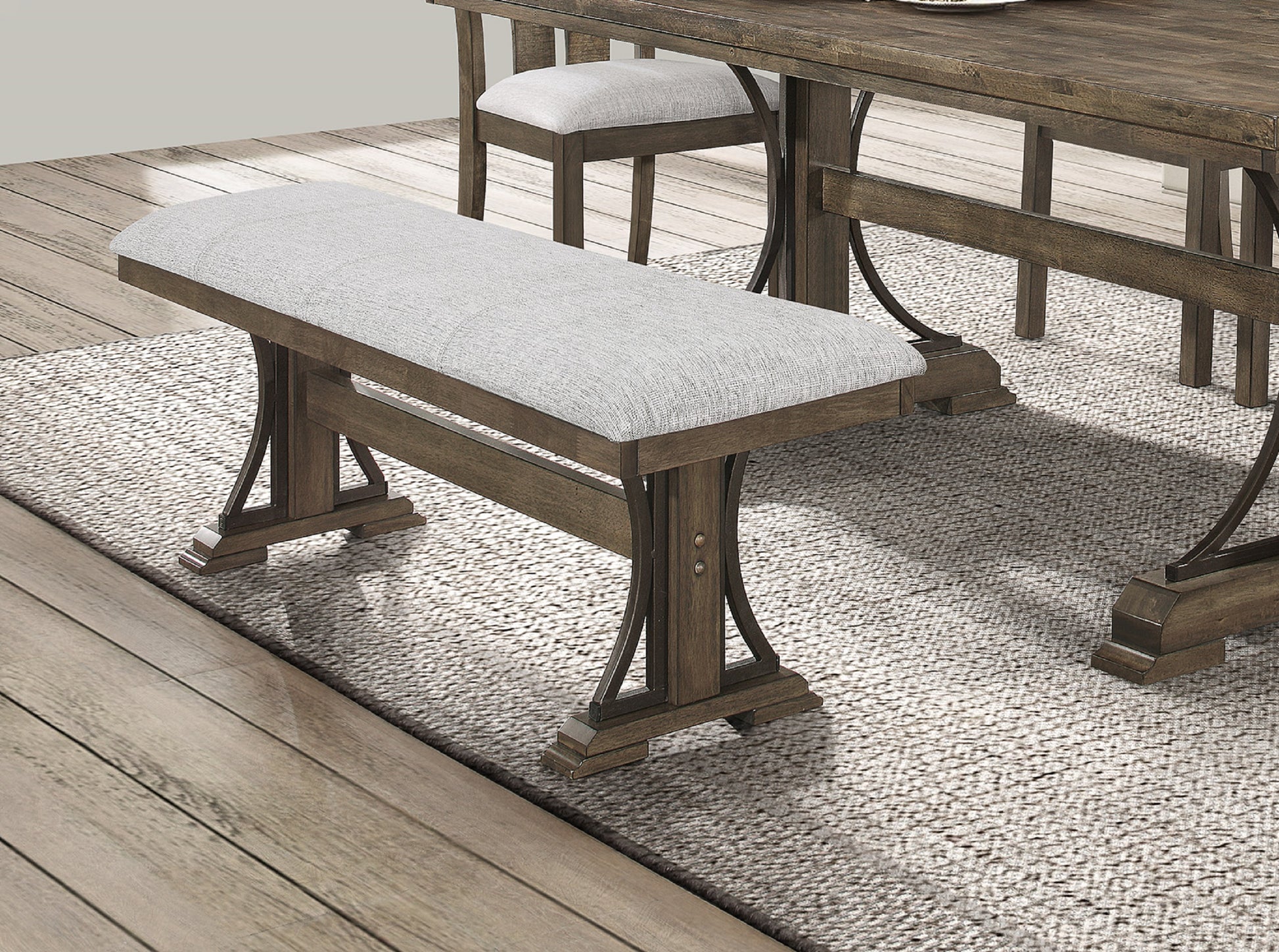 Farmhouse dining bench with upholstered light gray seat and dark wood frame