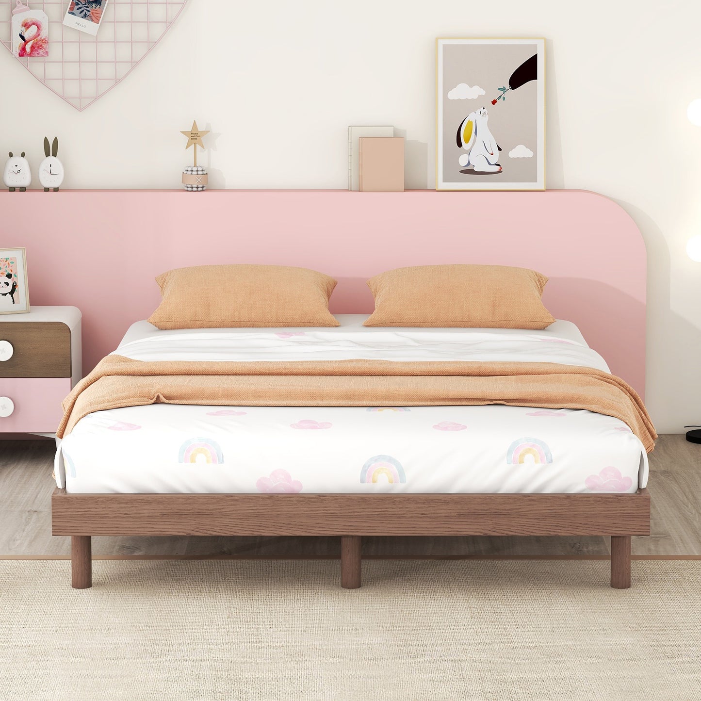 Wooden bed frame with rainbow cloud duvet cover and orange pillows