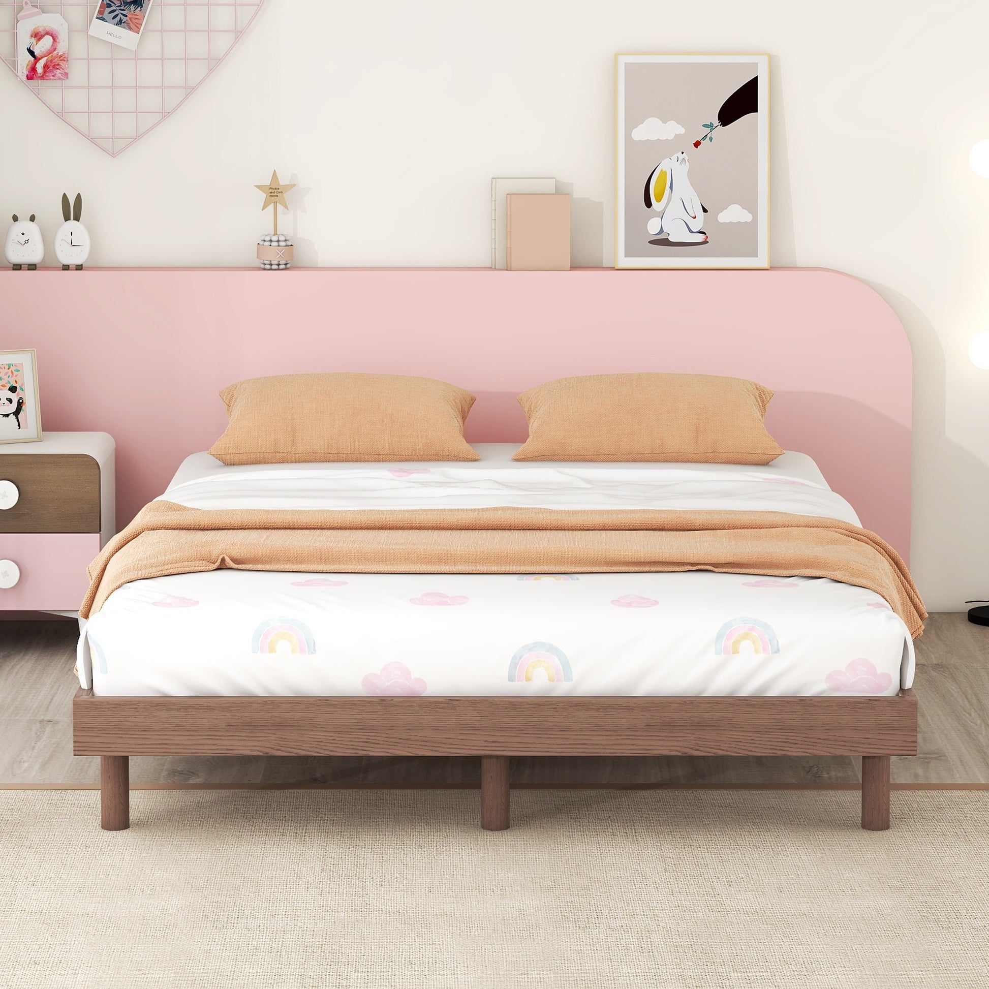 Wooden bed frame with rainbow cloud duvet cover and orange pillows