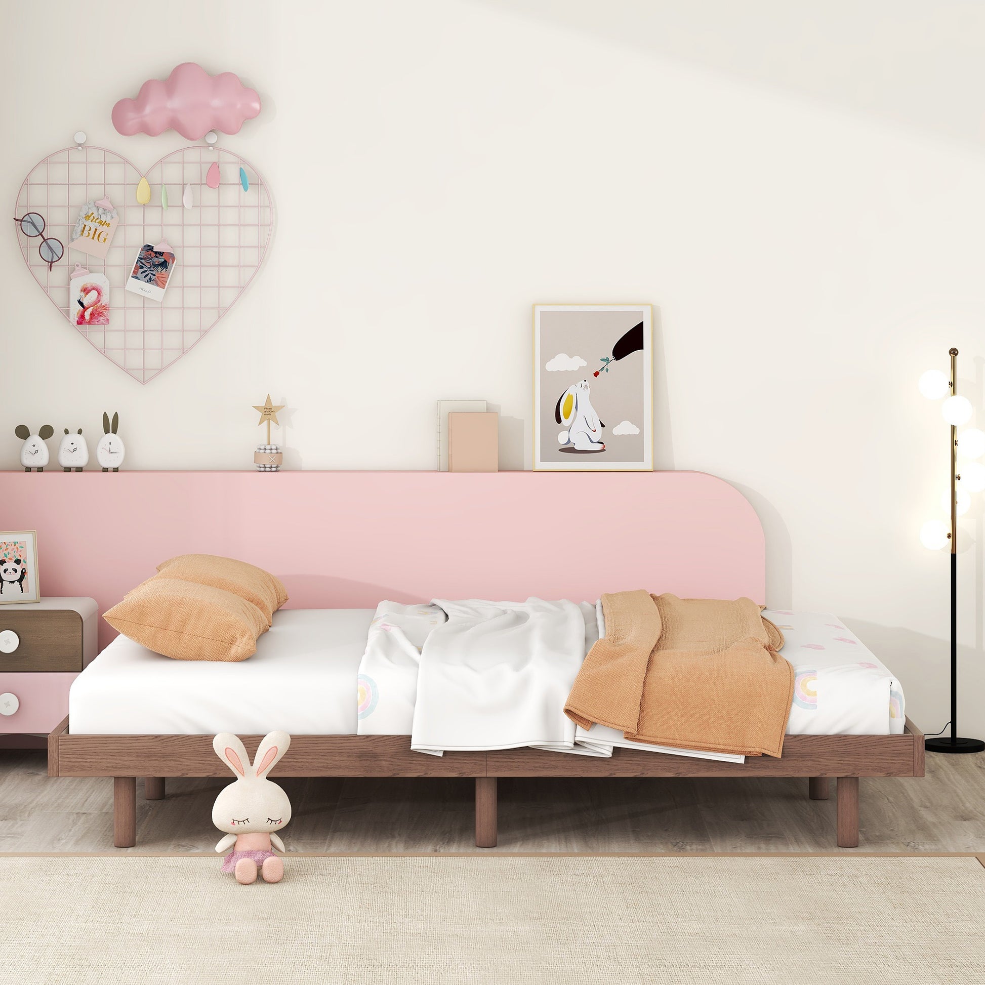 Wooden bed frame with pastel pink headboard and white bedding
