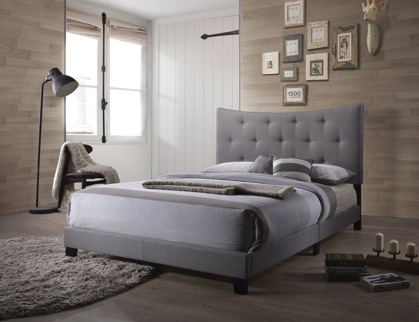 Grey fabric upholstered bed with tufted headboard and striped bedding