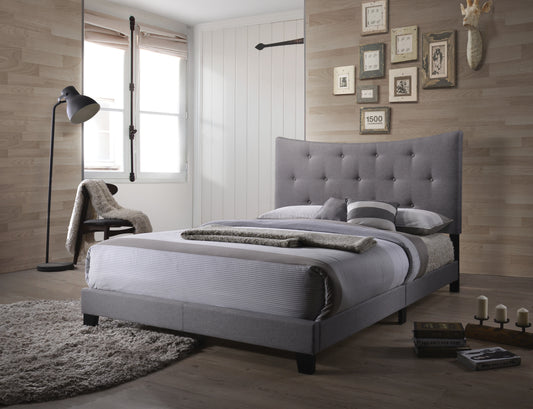 Grey fabric upholstered bed with tufted headboard and striped bedding