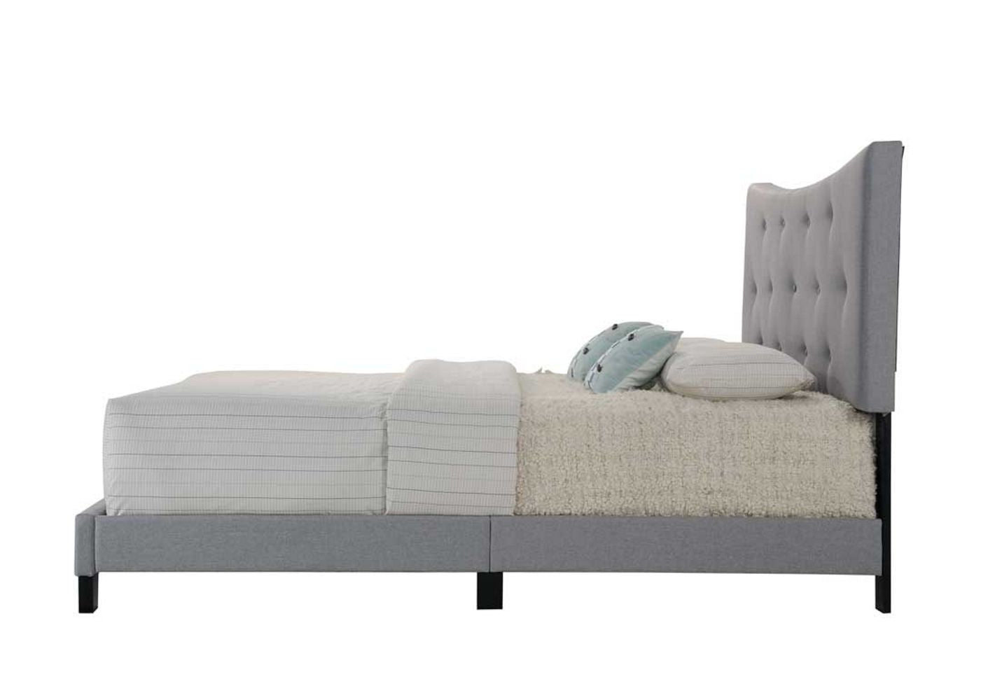 Tufted grey fabric headboard on a modern grey upholstered bed frame with striped bedding