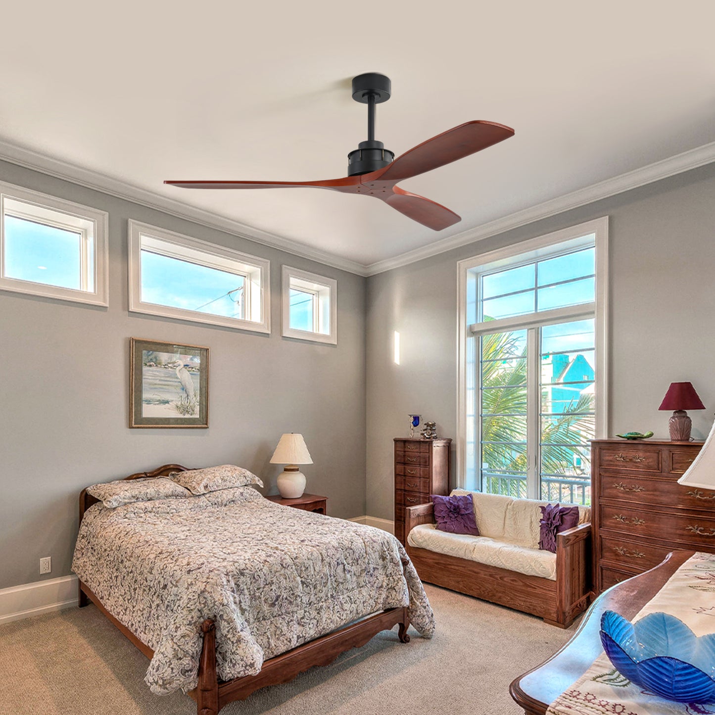 Modern black ceiling fan with three wooden blades providing cool airflow to bedroom