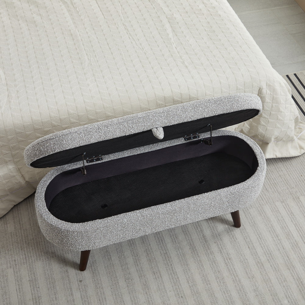 Gray fabric storage bench with open lid and dark interior ideal for bedroom or entryway