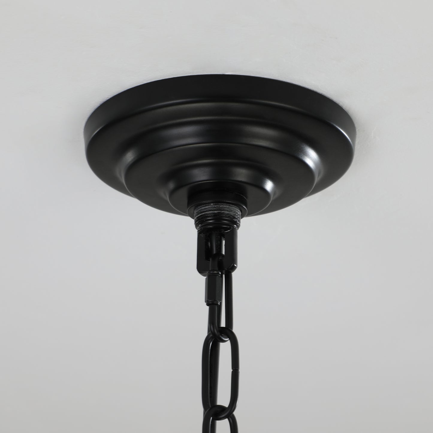 Black metal ceiling canopy with chain for hanging light fixture