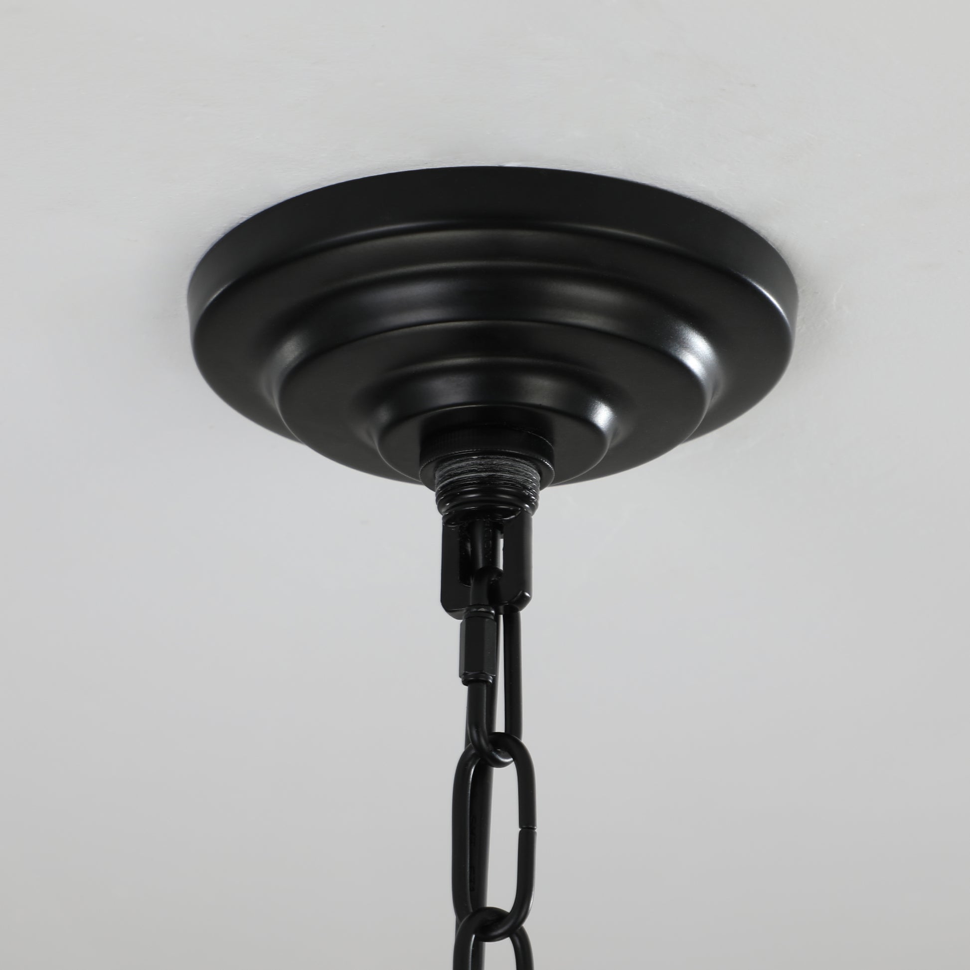 Black metal ceiling canopy with chain for hanging light fixture