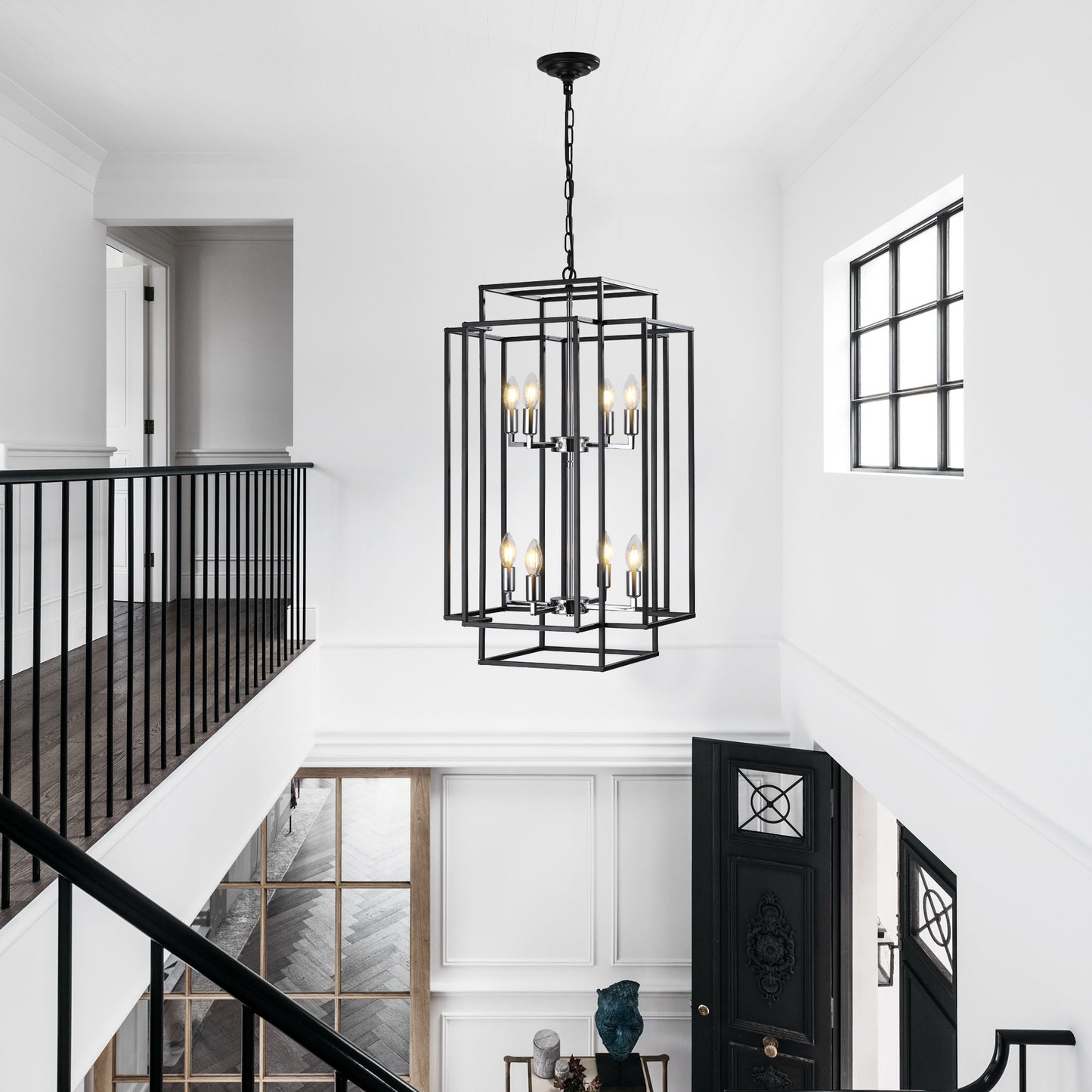 Black geometric chandelier with  bulbs illuminating a modern entryway