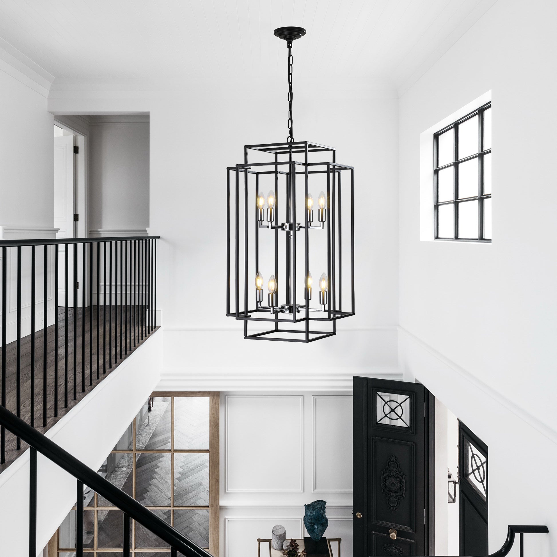 Black geometric chandelier with  bulbs illuminating a modern entryway
