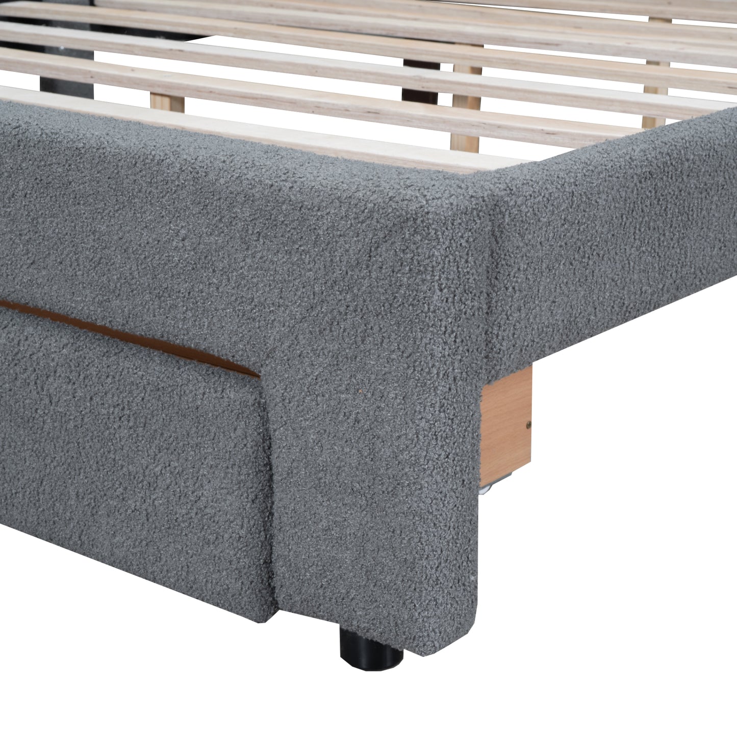 Closeup of grey textured boucle fabric bed frame corner with wooden slats