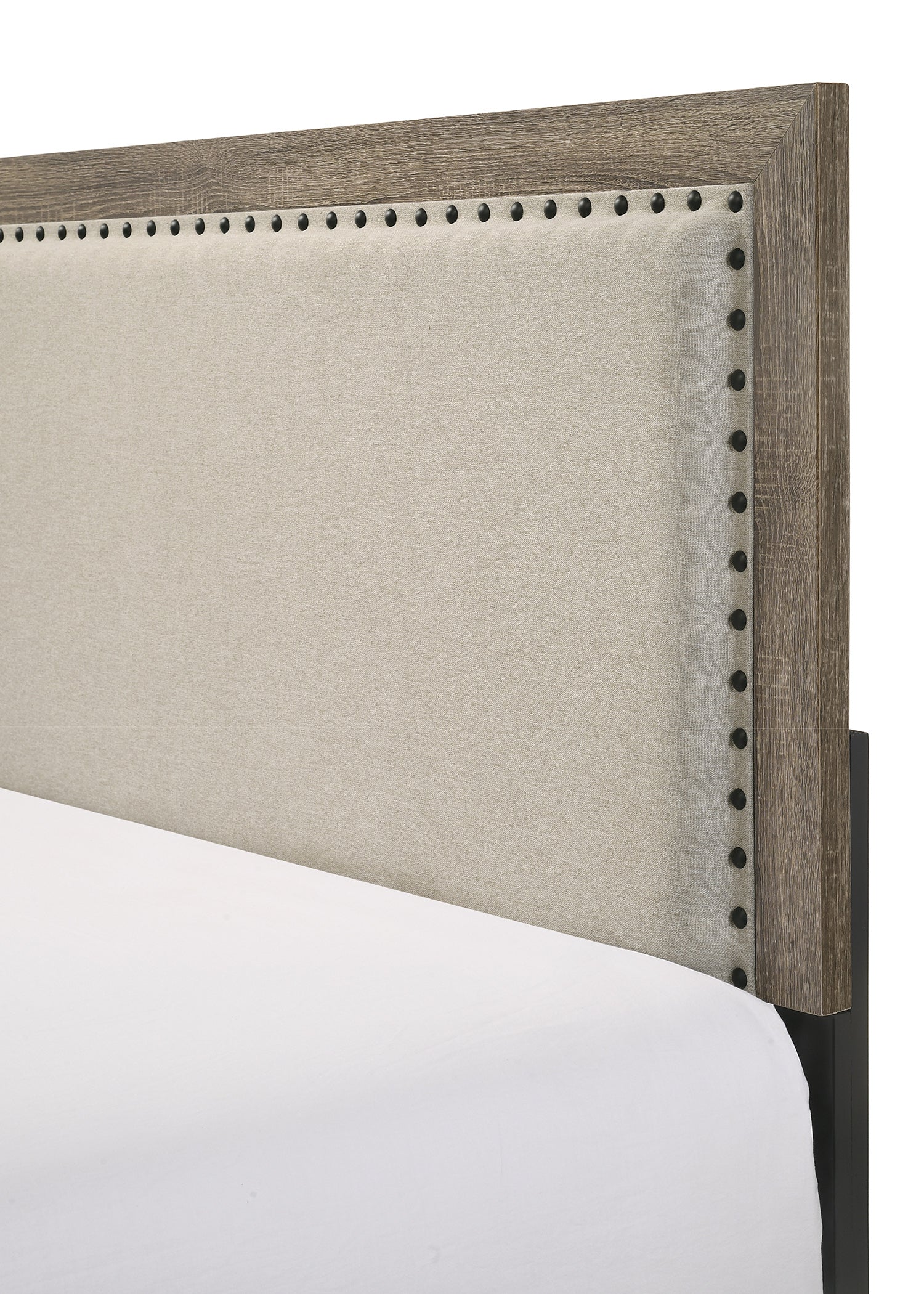 Neutral upholstered headboard with distressed wood frame and nailhead trim