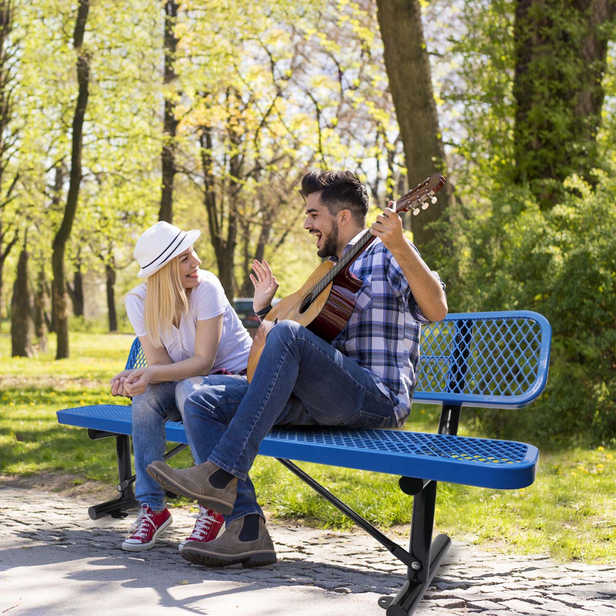 Blue metal park bench with diamond pattern seating for two ideal for outdoor relaxation