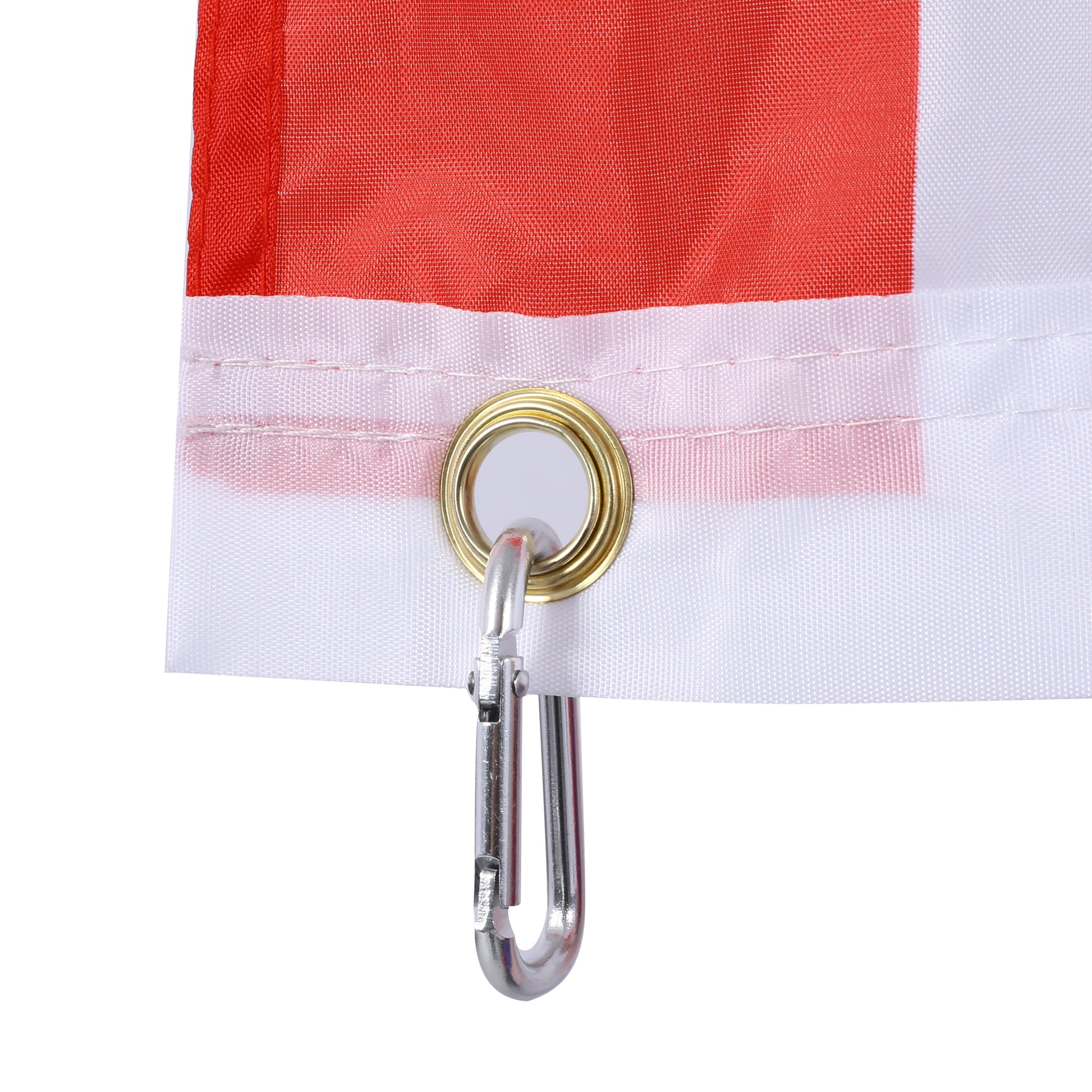 Closeup of red and white striped flag fabric with metal grommet and carabiner clip