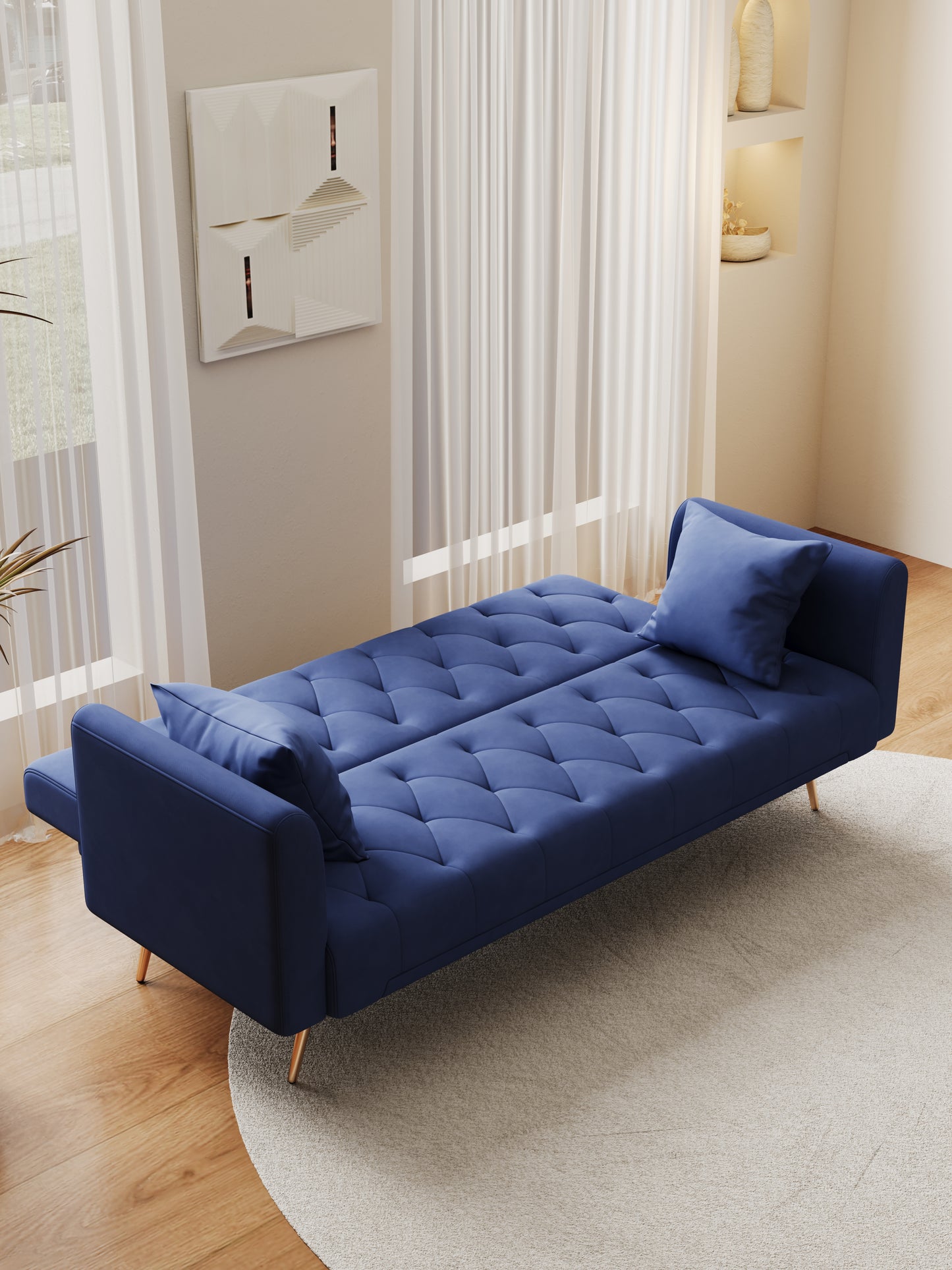 Deep blue velvet sofa bed with tufted upholstery and gold legs