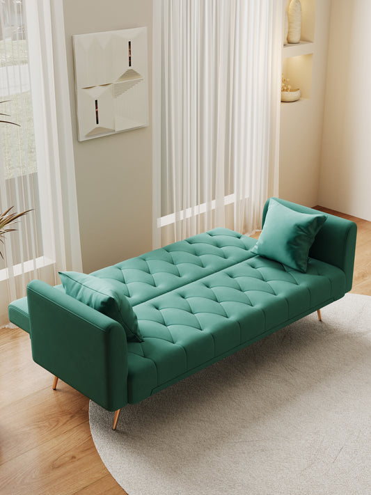 Tufted emerald green futon sofa with gold legs and matching throw pillows