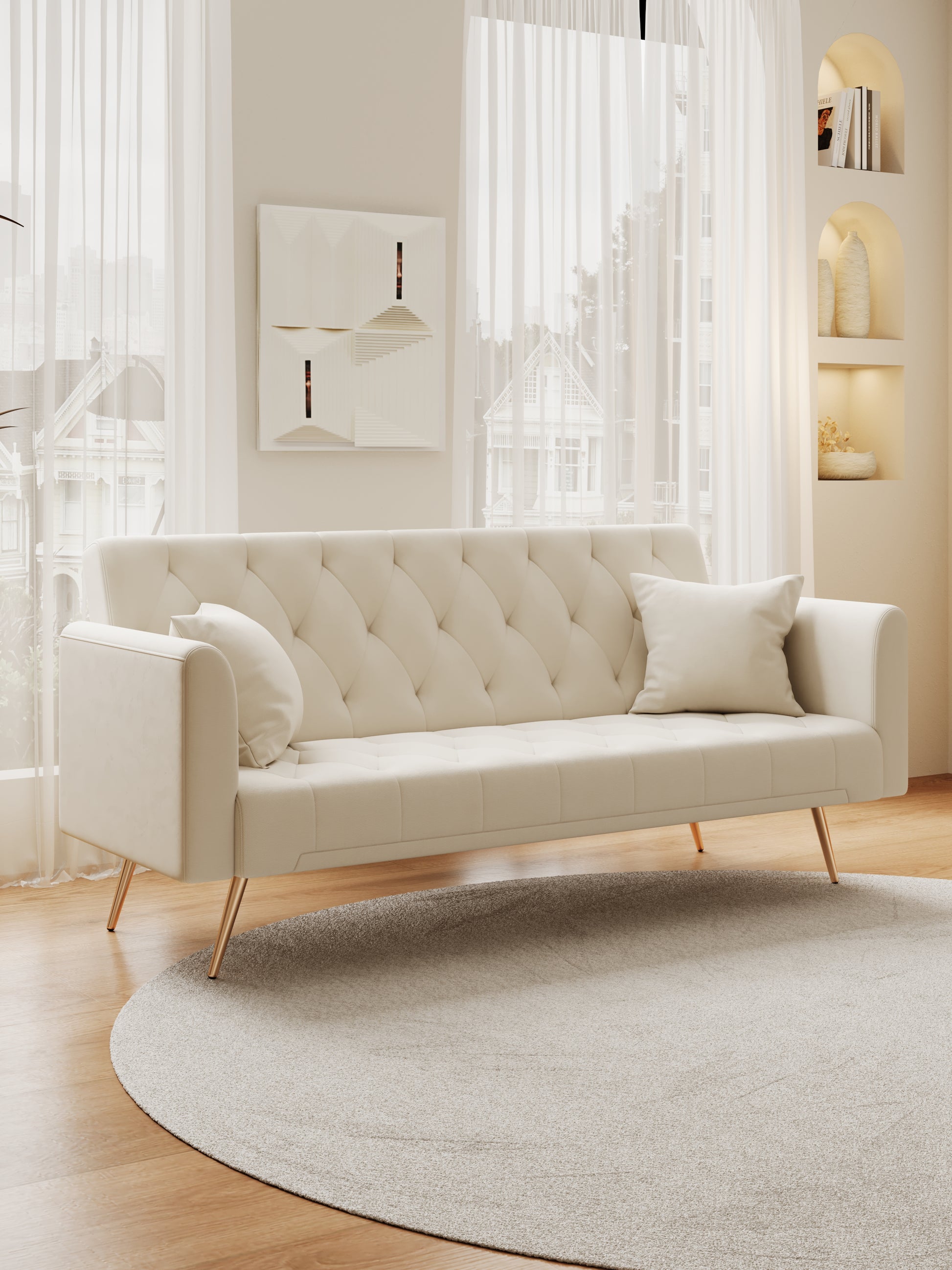 Cream velvet tufted sofa with gold legs and two accent pillows