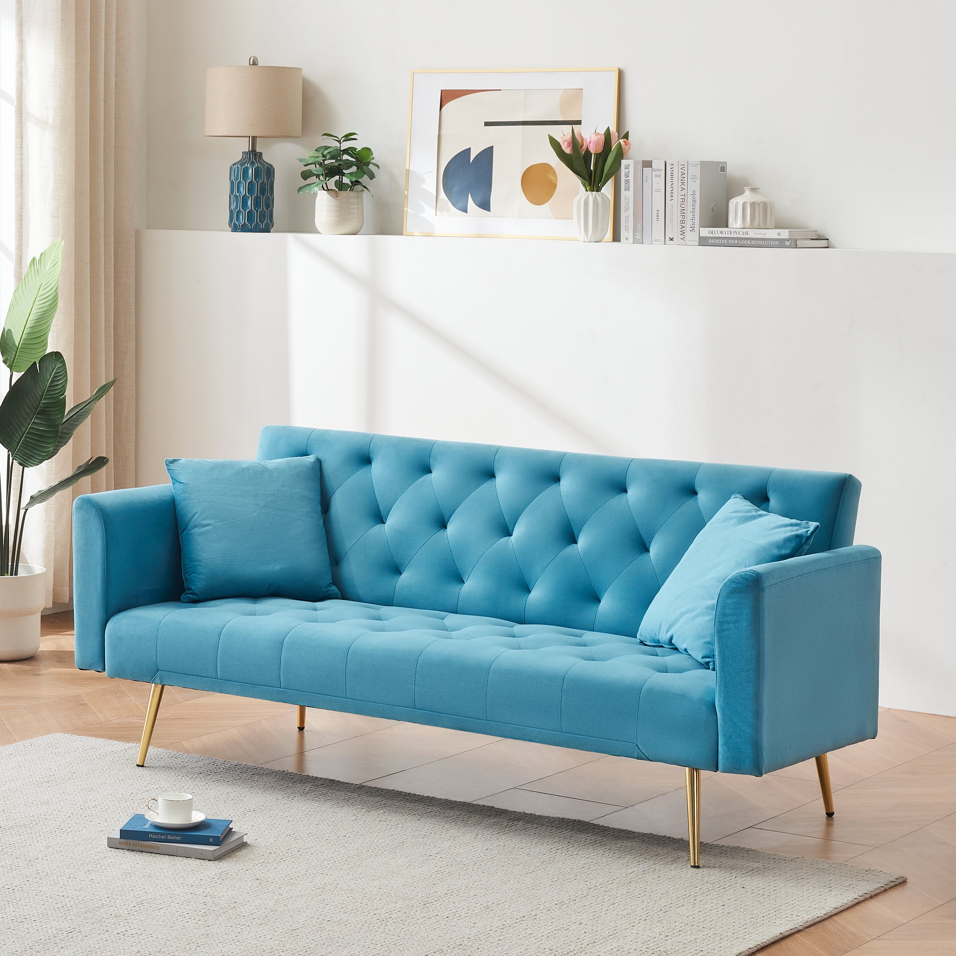 Teal velvet tufted sofa with gold legs and accent pillows ideal for living rooms