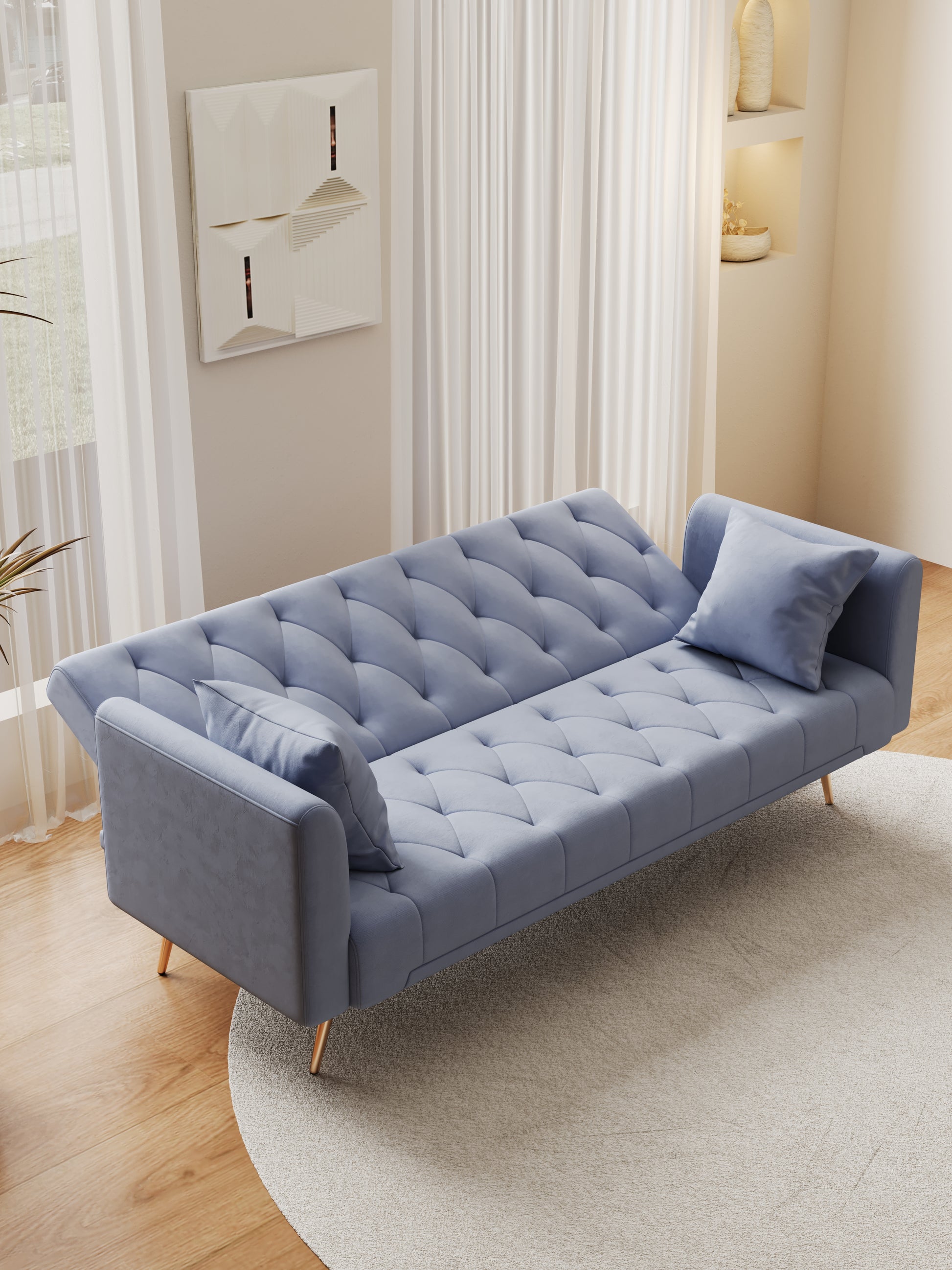 Dusty blue velvet sofa with tufted cushions and golden legs perfect for small living spaces