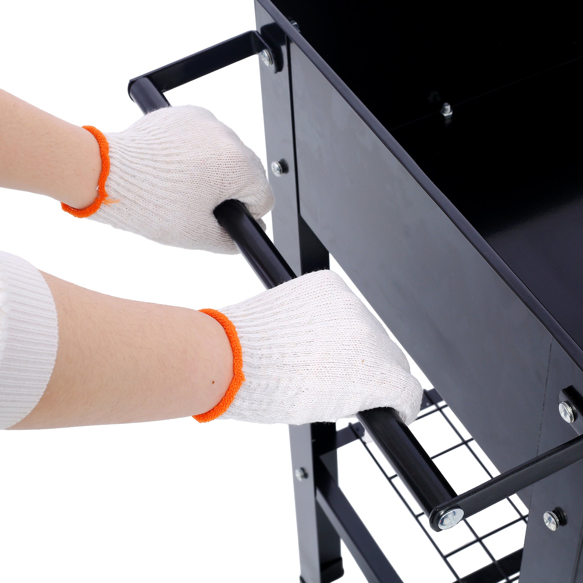 Hands in white gloves assembling black charcoal grill showing side handle attachment