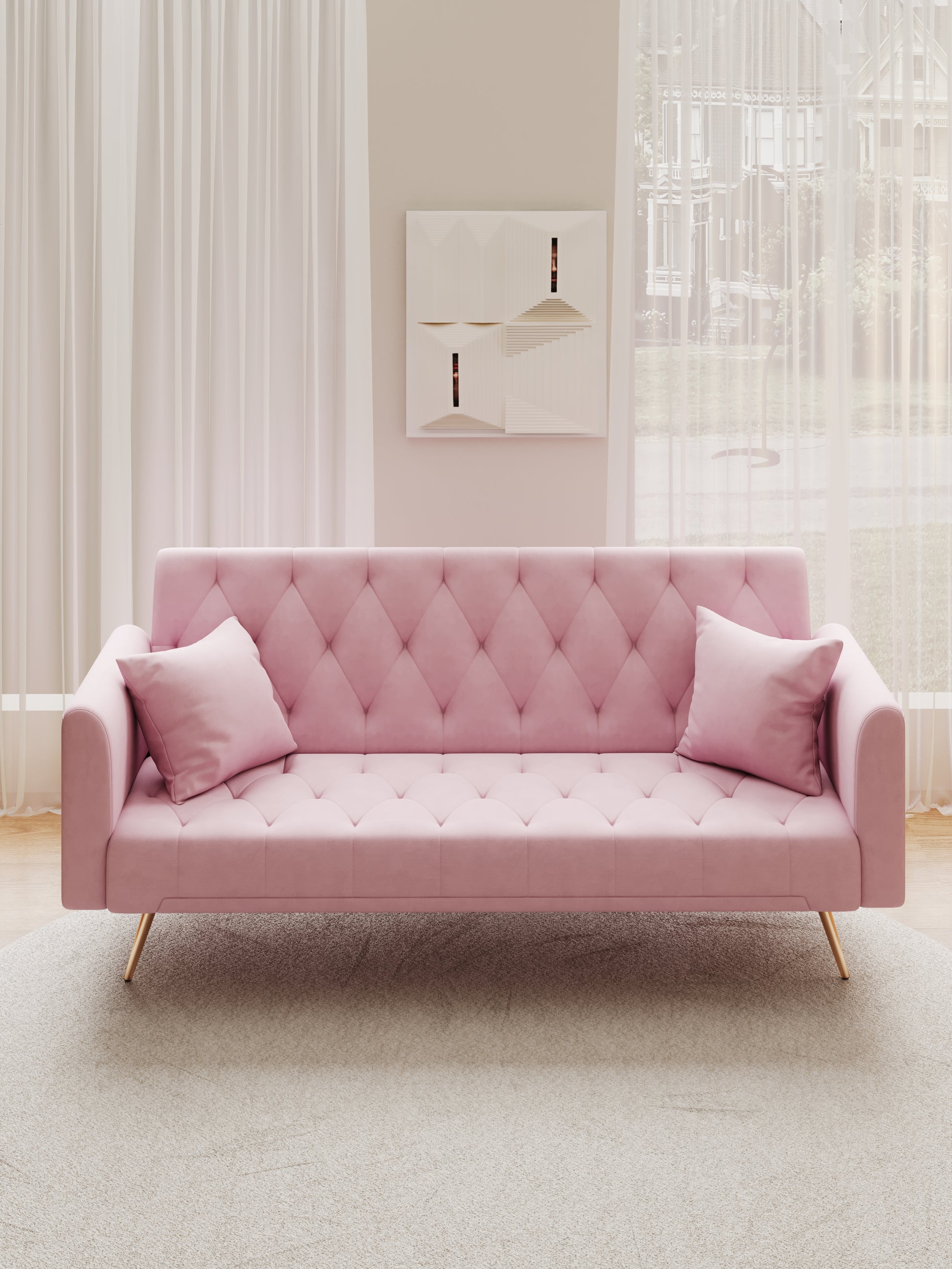 Pink velvet tufted sofa with gold legs and decorative pillows