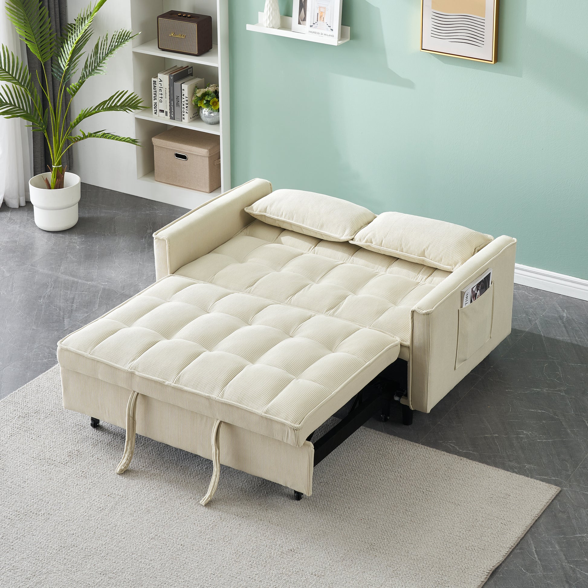 Cream corduroy sofa bed with tufted cushions and pullout footrest