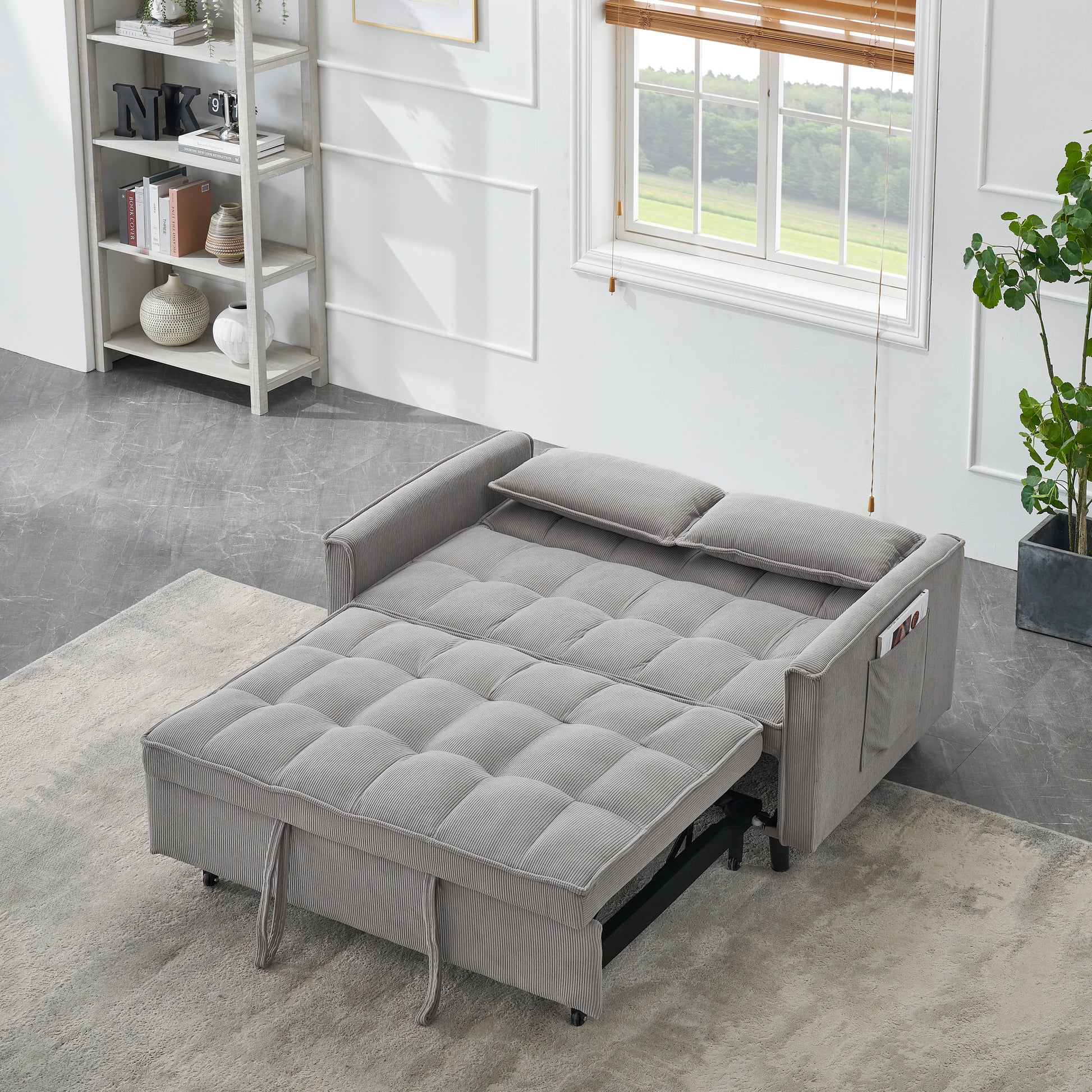 Gray corduroy sofa bed with tufted cushions and pull tabs for adjustment
