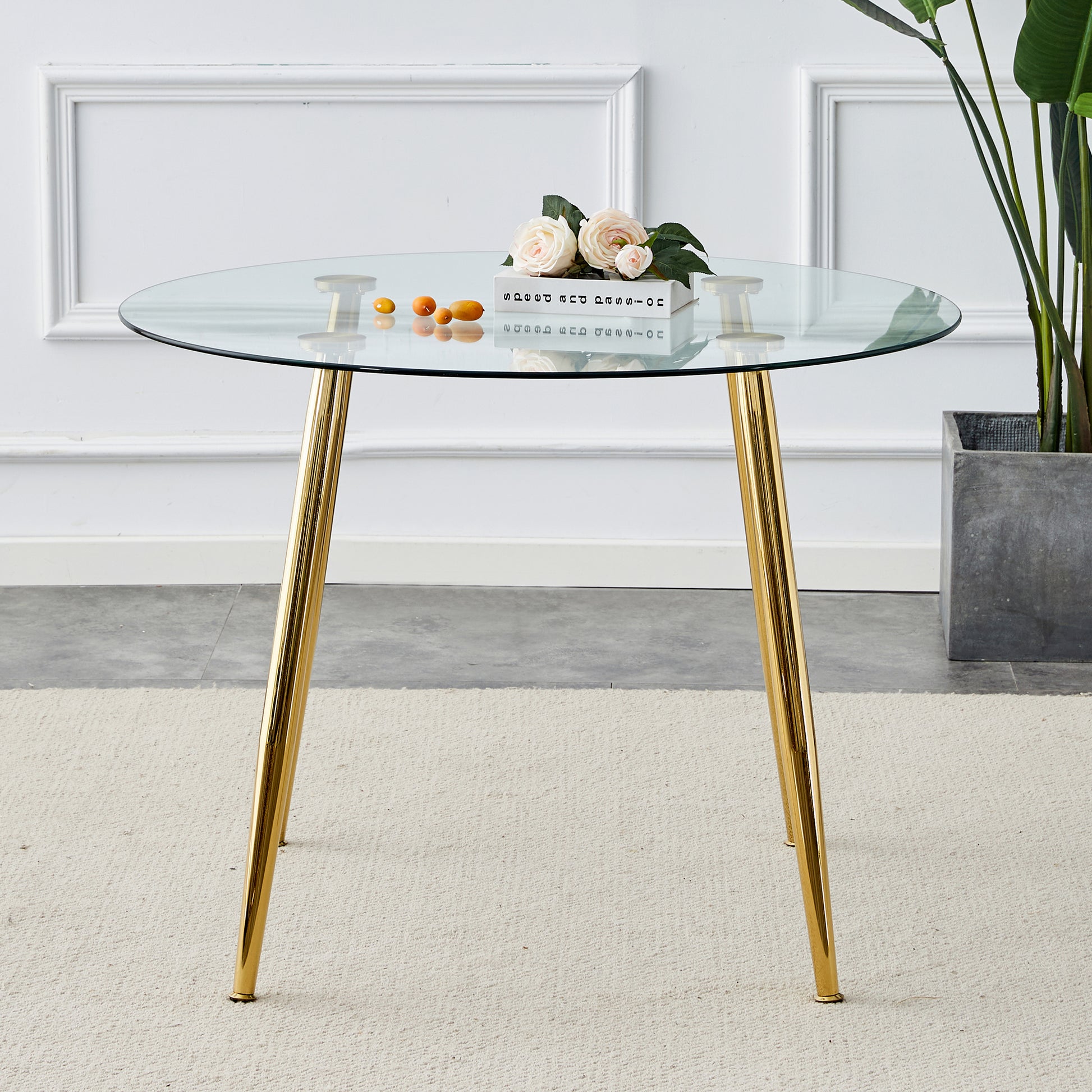 Round glass dining table with polished gold metal legs elegant and modern design