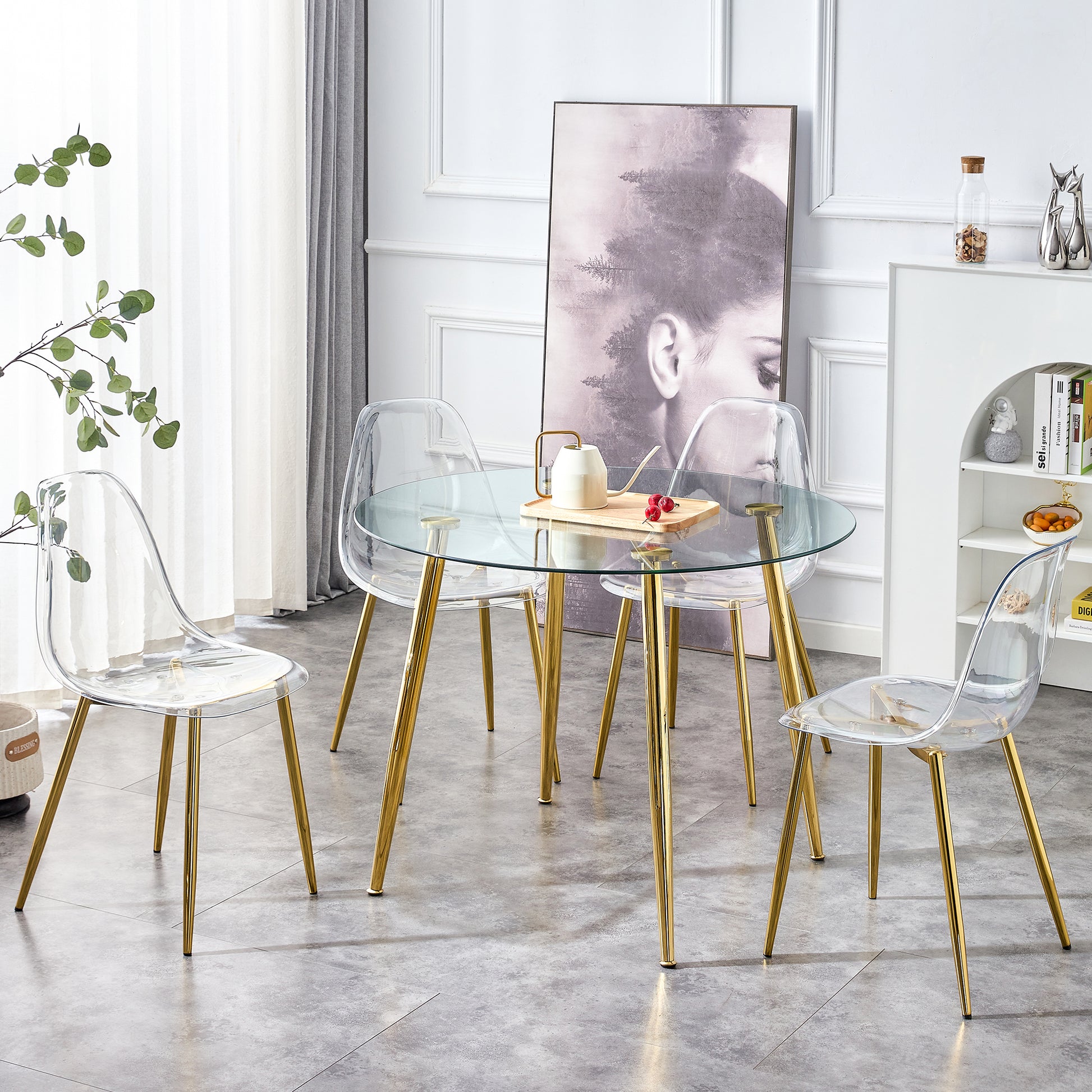 Round glass dining table with four clear acrylic chairs and gold legs