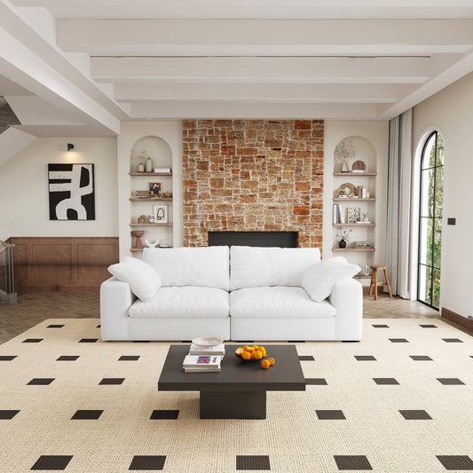 Plush white sectional sofa with deep cushions and textured fabric