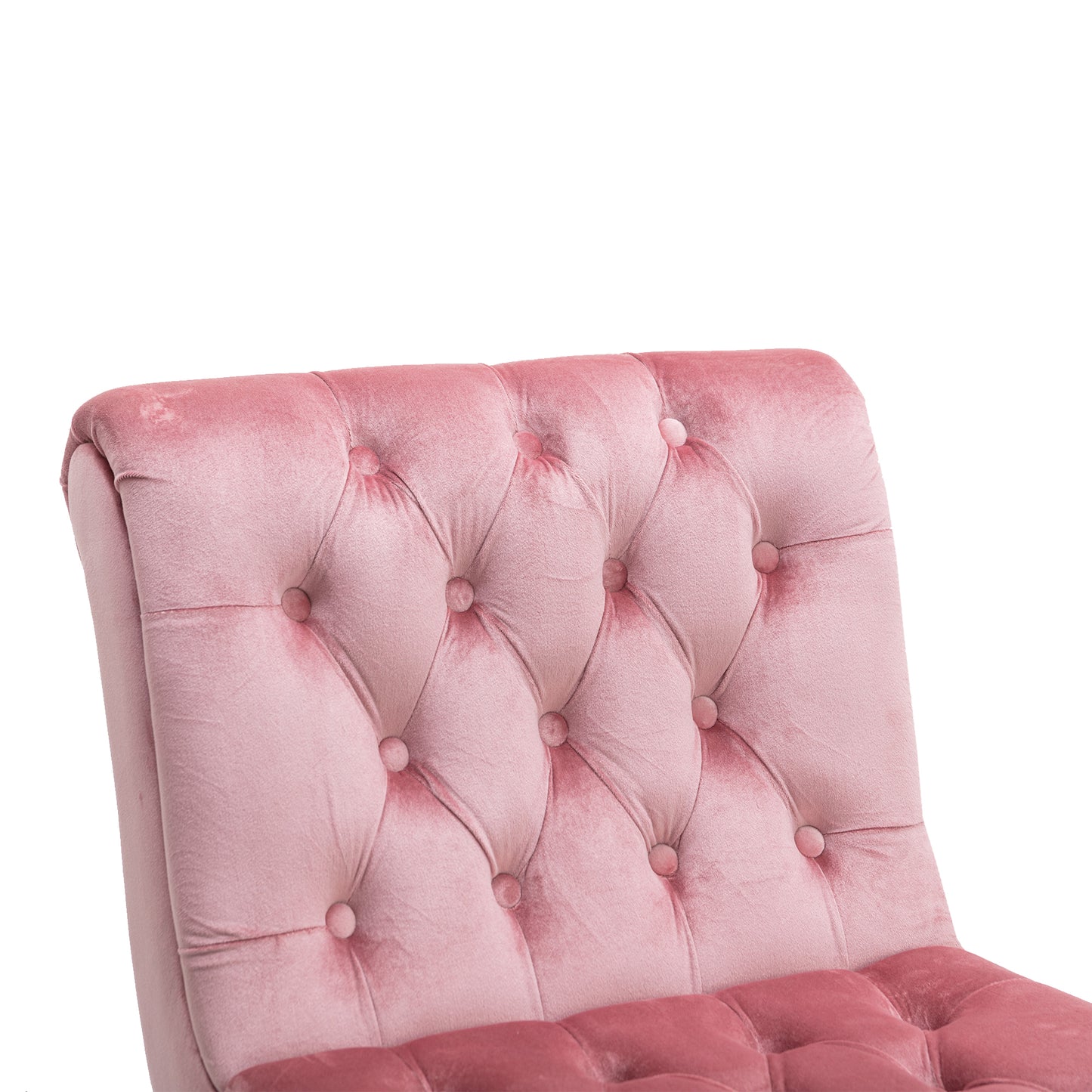 Closeup of a plush pink velvet armchair with diamond tufting and button accents