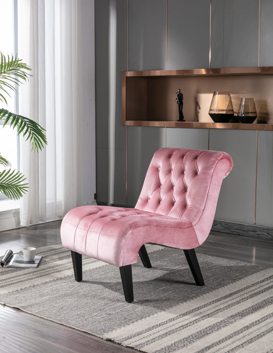 Elegant pink velvet accent chair with tufted button details and black tapered legs