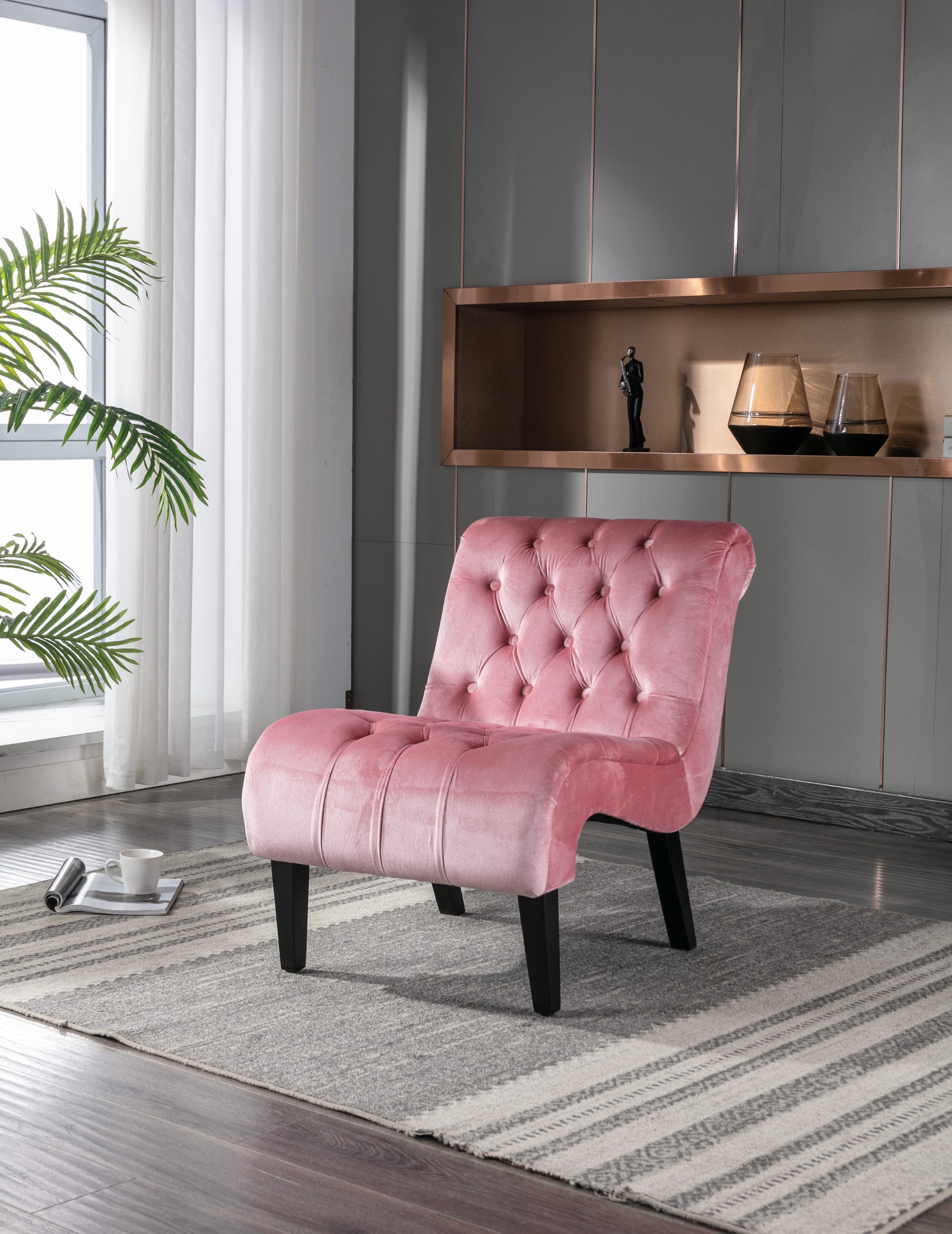 Pink velvet accent chair with button tufting and curved back for a stylish living room