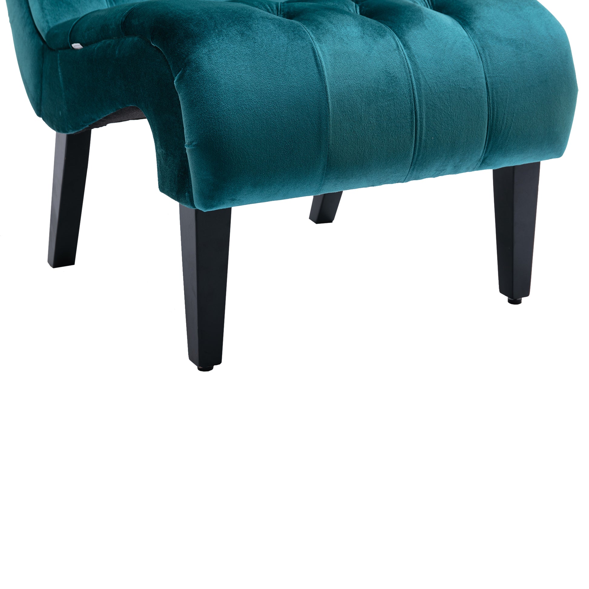 Closeup of a teal velvet accent chair with tufted detailing and black wooden legs