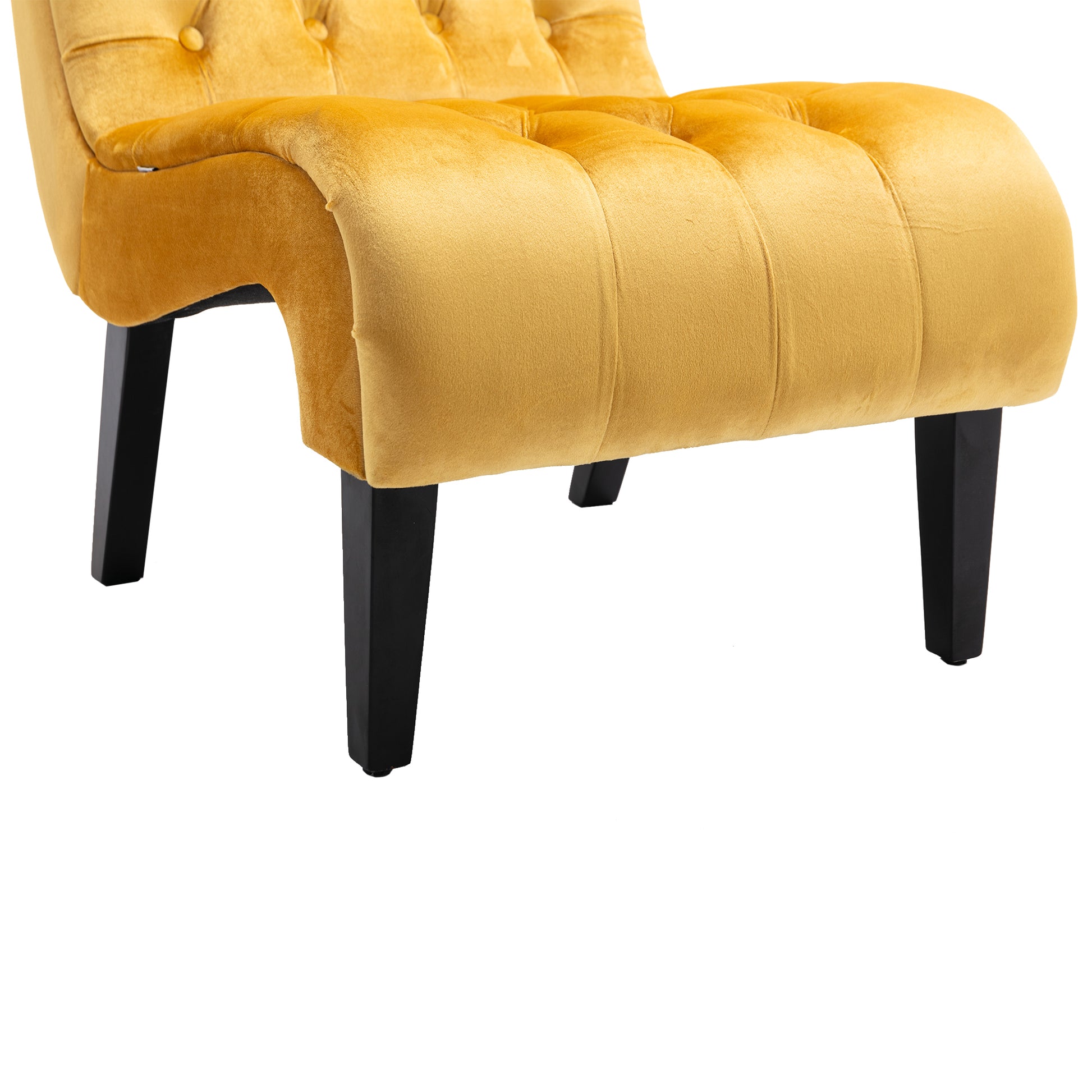 Closeup of a mustard yellow velvet accent chair with tufted details and black tapered legs