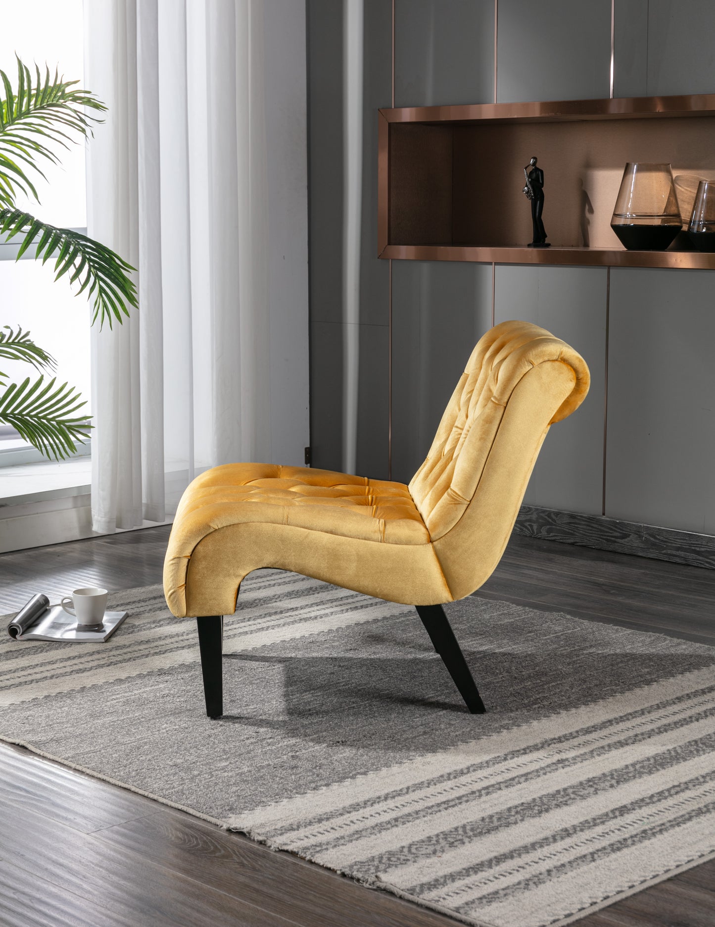 Tufted velvet accent chair in mustard yellow with black tapered legs providing stylish seating